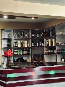 a bar with a bunch of bottles of alcohol at Prashiddha Resort in Dakshīnkāli