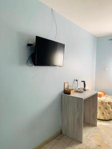 a living room with a tv on a wall at Solovina Guest House in Foso