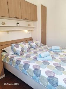 a bedroom with a bed with pillows on it at The Golden Island apartments in Krk