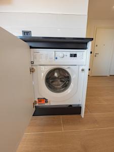 a washing machine in the corner of a kitchen at Noli Blue Bay in Noli