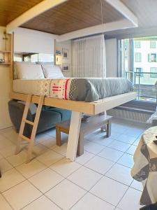 a bunk bed in a room with a large window at Ladybird Inn in Chamonix