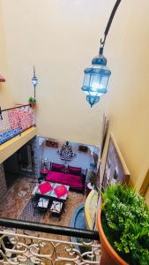 a view of a living room with a couch and a light at Riad Layla Rouge in Marrakesh