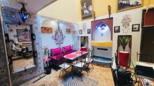 a room with a table and a couch in it at Riad Layla Rouge in Marrakesh