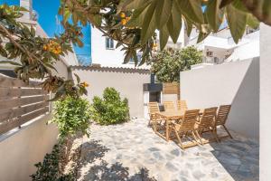 a patio with chairs and a table in front of a building at Dimasti Apartment in Rhodes Town