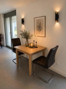 a dining room with a wooden table and chairs at Lux Apartments in Lichtenfels