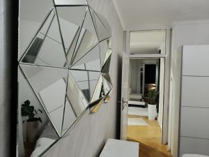 a glass wall in a hallway with a mirror at White Lounge Haustor in Podgorica