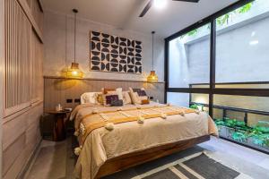 a bedroom with a bed and a large window at Luxury Beachfront 4BR PH in Bahia Soliman in Balcheil +43 photos