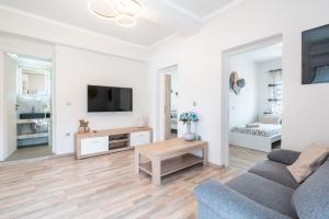 a living room with a couch and a tv at Dimasti Apartment in Rhodes Town
