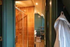 a bathroom with a shower and a toilet and a towel at The Rising Sun - Pensford in Pensford