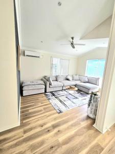 a living room with a couch and a table at Serena Shores Holiday Escape in St Georges Basin +22 photos