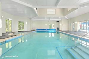 a large swimming pool with blue water at Serena Shores Holiday Escape in St Georges Basin