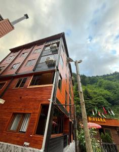 a wooden building with windows on the side of it at Nirvana Suite Hotel in Uzungöl