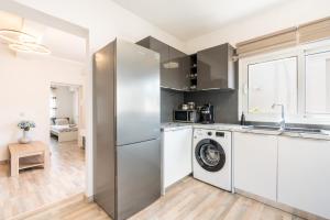a kitchen with a refrigerator and a washing machine at Dimasti Apartment in Rhodes Town
