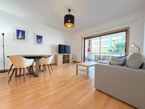 a living room with a couch and a table at Casa Joaninha in Olhão