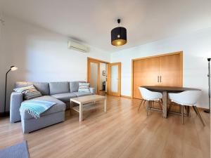 a living room with a couch and a table at Casa Joaninha in Olhão