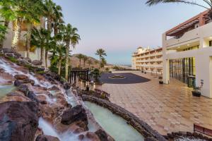 a view of a resort with a waterfall at Occidental Jandía Mar - All Inclusive in Morro del Jable