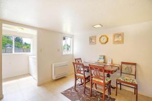a room with a table and chairs and a clock at You Won't Be Crabby After Staying Here in Westport
