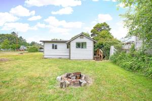 a yard with a white house and a building at You Won't Be Crabby After Staying Here in Westport