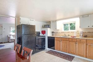a kitchen with a black refrigerator and wooden cabinets at You Won't Be Crabby After Staying Here in Westport