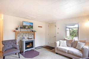 a living room with a couch and a fireplace at You Won't Be Crabby After Staying Here in Westport