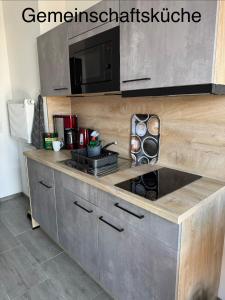 a kitchen with a stove and a microwave at Downtown 38 in Wittenberge