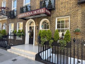 a hotel with a sign on a brick building at Americana Hotel in London
