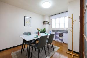 a kitchen and dining room with a table and chairs at Desroches House in Kanazawa