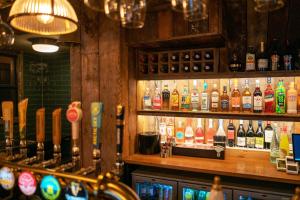 a bar with a lot of bottles of alcohol at The Rising Sun - Pensford in Pensford +5 photos