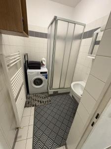 a bathroom with a washing machine and a toilet at Palace Apartment in Vienna +35 photos