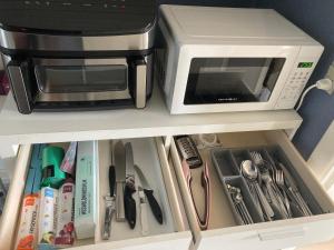 a microwave oven sitting on top of a cabinet at Private country side apartment in Holstebro