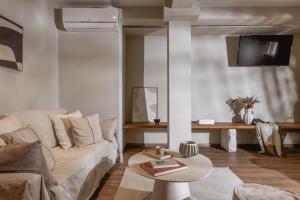 a living room with a couch and a table at Ederlezi Boutique Hotel in Athens