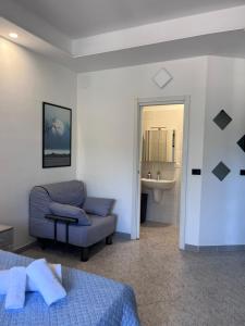 a bedroom with a bed and a chair and a sink at B&B a casa di Sonia in Termoli +62 photos