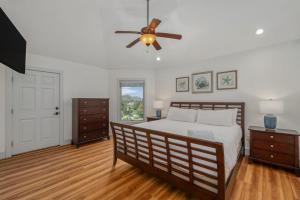 a bedroom with a bed and a ceiling fan at Heron Landing in Corolla