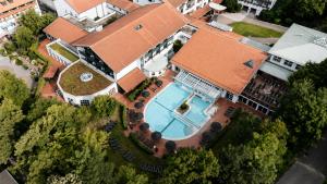 an overhead view of a house with a swimming pool at DAS LUDWIG Sports Resort in Bad Griesbach +35 photos