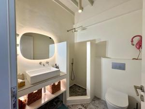 a bathroom with a sink and a mirror at Patmos Cliff House in Patmos +59 photos