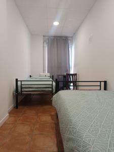 a bedroom with a bed and a table and chairs at Nest Room in Alicante