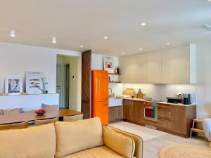 a kitchen with a couch and a table in a room at Patmos Cliff House in Patmos
