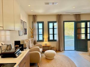 a living room with a couch and chairs in it at Patmos Cliff House in Patmos