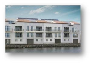 a large white building with solar panels on it at Port Rive Gauche Roseliere in Marseillan