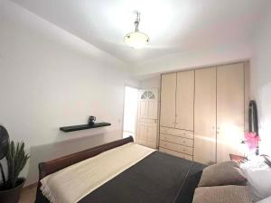 a bedroom with a large bed and a closet at Castelli Retreat in Spetses +28 photos