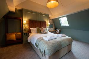a bedroom with a bed with two towels on it at The Rising Sun - Pensford in Pensford
