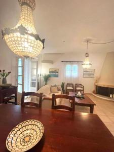 a living room with a table and chairs and lights at Castelli Retreat in Spetses