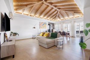 a living room with a couch and a table at Flor de Sol House in Tavira