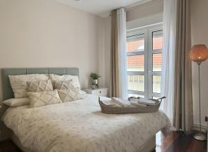 a bedroom with a large bed with a window at Apartamento La Bruma 30807 in Somo