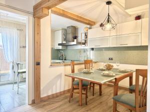 a kitchen and dining room with a table and chairs at Apartamento La Bruma 30807 in Somo