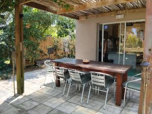 a wooden table and chairs on a patio at Bosque del Este in Balneario Buenos Aires