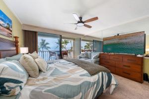 a bedroom with a bed and a ceiling fan at Maui Beachfront Haven 433 in Lahaina +69 photos