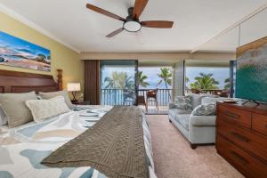 a bedroom with a bed and a ceiling fan at Maui Beachfront Haven 433 in Lahaina