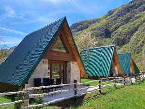 a cabin in the mountains with a green roof at Eco resort Komarnica in Šavnik