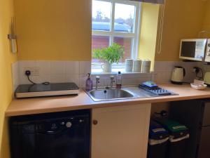 a kitchen counter with a sink and a window at Jakels Rest in Lairg